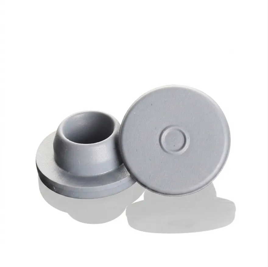 Two light gray butyl stoppers showing the top face and hollow plug