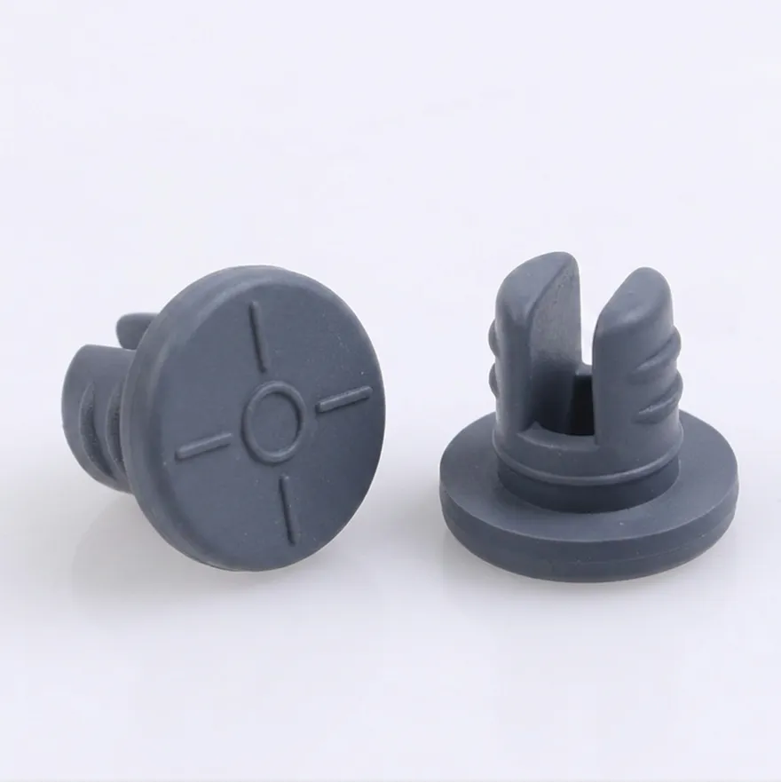 Two dark blue-gray butyl lyophilization stoppers, one showing the slotted plug