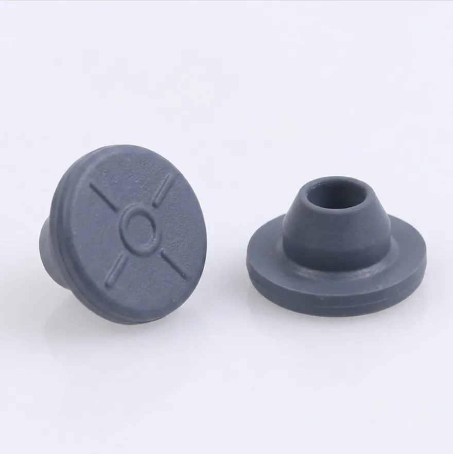 Two blue-gray butyl serum stoppers, one upright and one inverted showing the plug