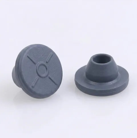 Two blue-gray butyl serum stoppers, one upright and one inverted