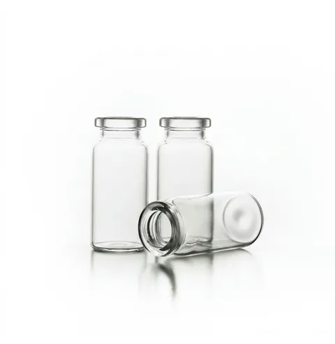 Three clear glass vials, one lying on its side