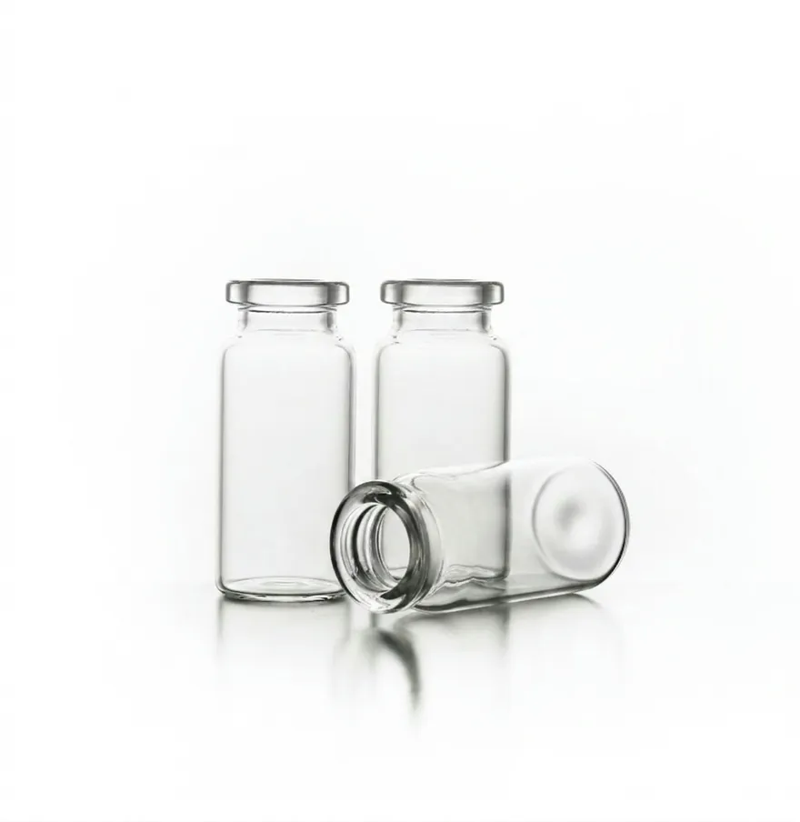 Three clear borosilicate glass vials, one lying on its side